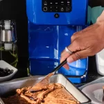 person cutting brownie that is infused by levo oil machine