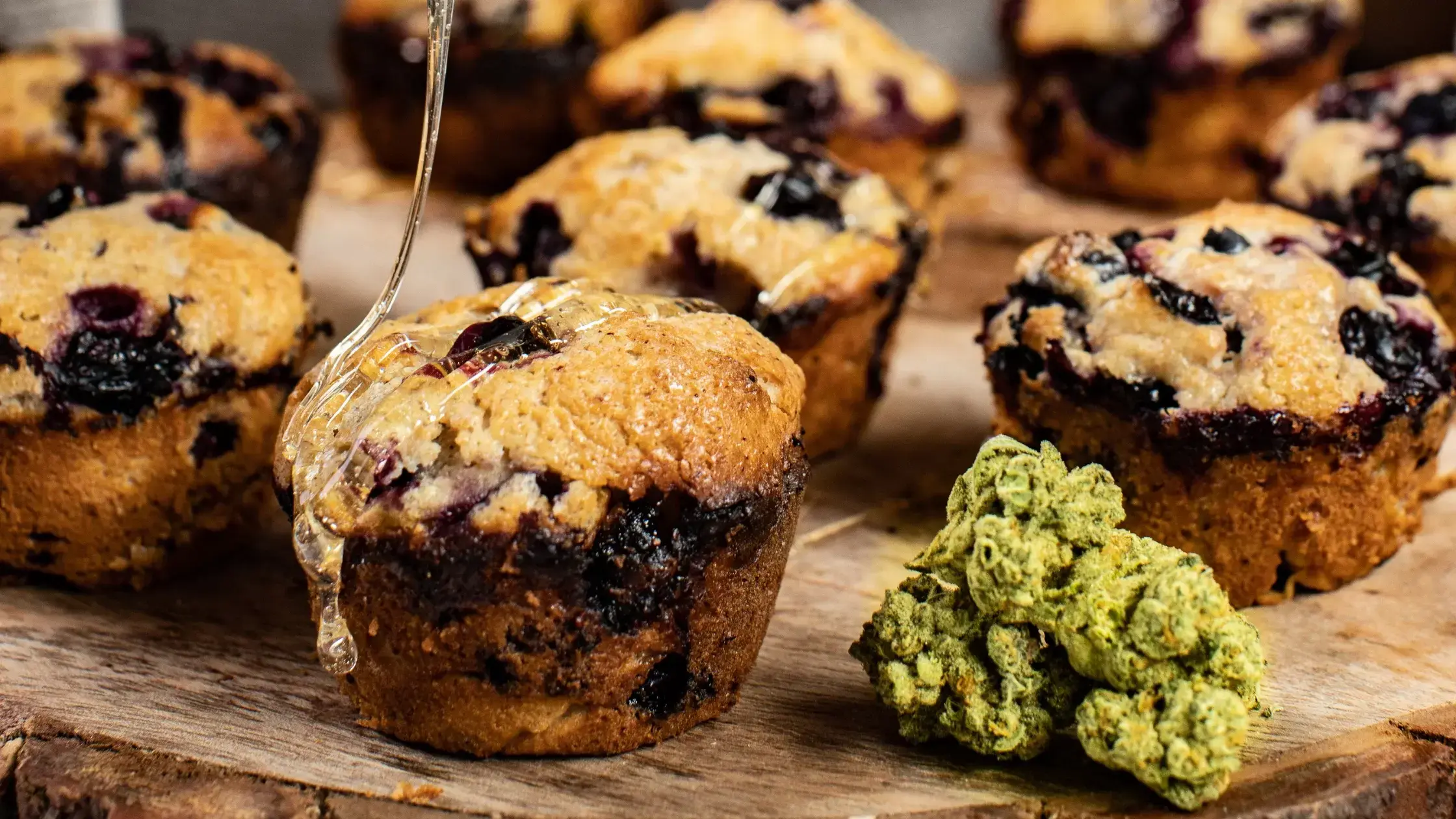 Rustic CBD blueberry muffins next to a nug.