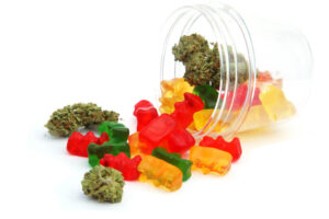 Gummy bears made with the edible ratio calculator and cannabis flower spilling out of a jar